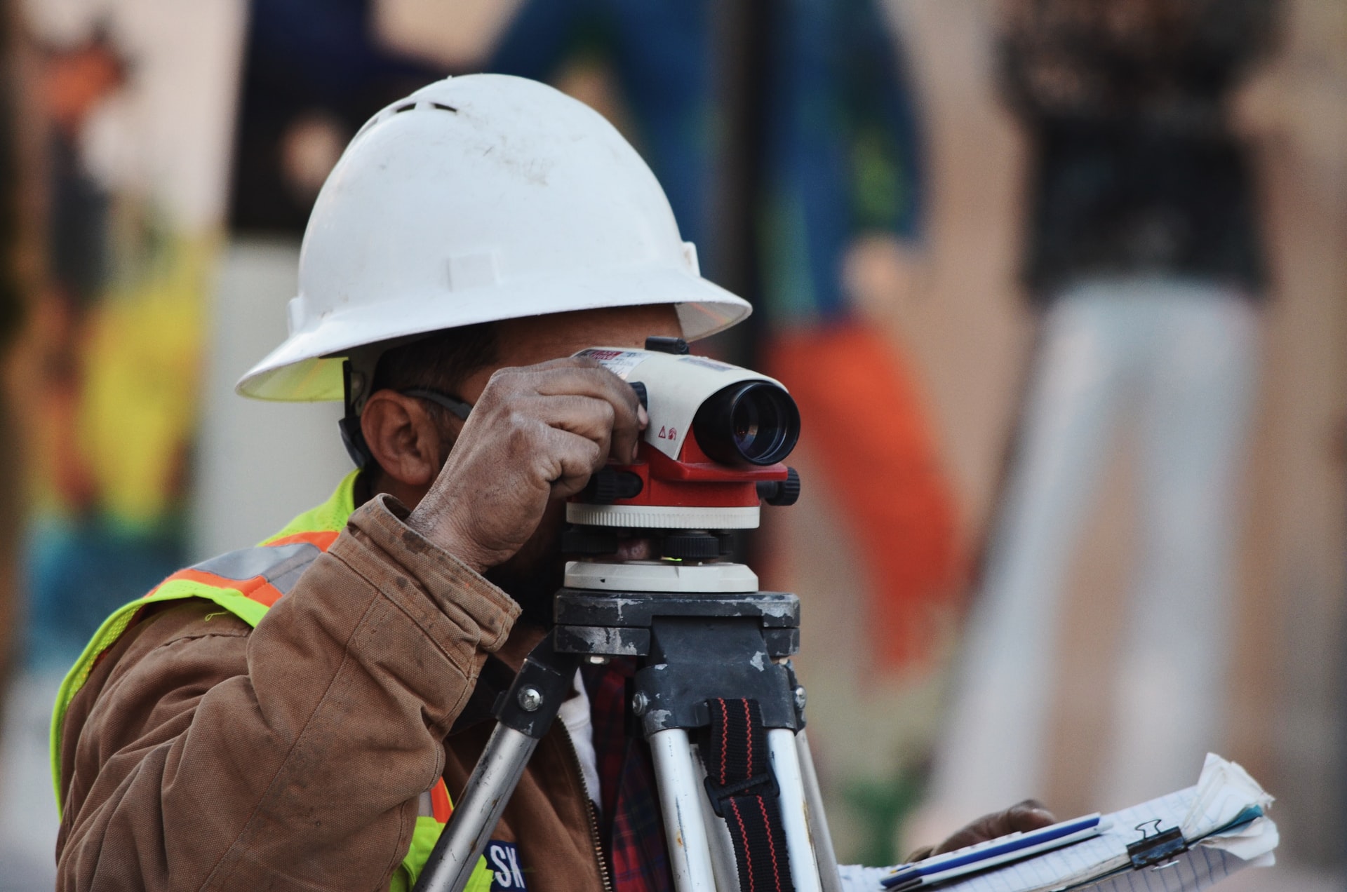Surveyors servicing a property to complete elevation certificate. Photo by <a href="https://unsplash.com/@morganvongunten?utm_source=unsplash&utm_medium=referral&utm_content=creditCopyText">Morgan Von Gunten</a> on <a href="/collections/4365752/surveyor?utm_source=unsplash&utm_medium=referral&utm_content=creditCopyText">Unsplash</a>